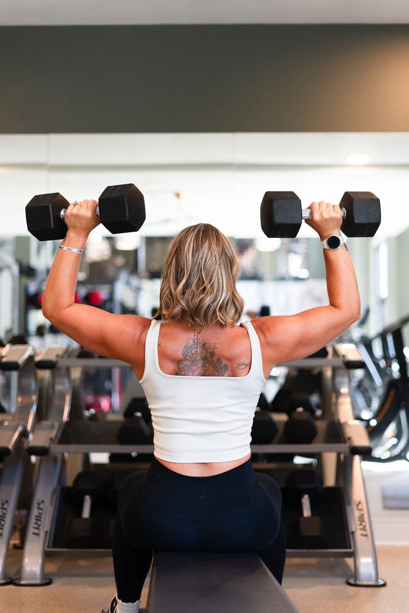 The coach is showing her back muscle.